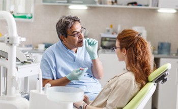 a dentist in Goodyear explaining how dental implants work