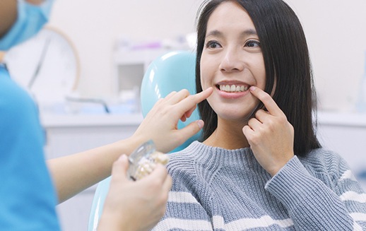 woman talking to cosmetic dentist in Goodyear