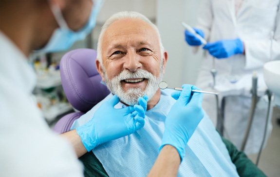 A smiling senior man happy with his dentures