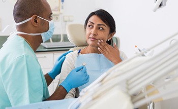 a patient visiting her dentist for an oral examination