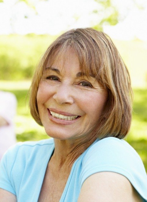 Older woman with flawless smile after full mouth reconstruction