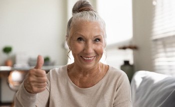 woman smiling after getting dental implants in Goodyear