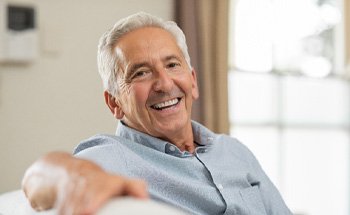 man smiling after getting dental implants in Goodyear