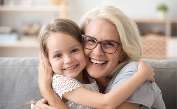 older woman hugging grandchild  