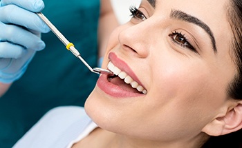 Woman receiving dental checkup from implant dentist in Goodyear