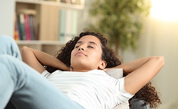 woman relaxing for dental implant post-op instructions in Goodyear