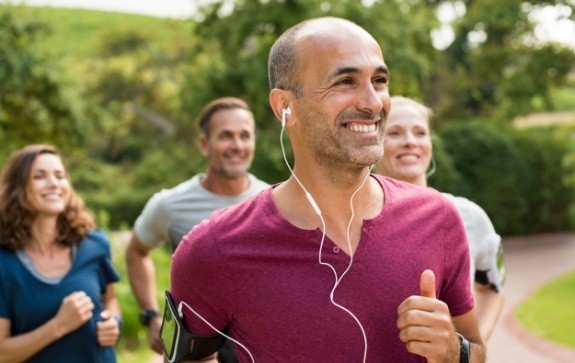 Smiling man running and enjoying the benefits of dental implants