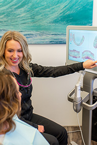 Friendly dental team member helping patient conquer dental anxiety