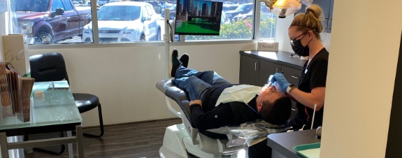 Dental team member examining dental patient