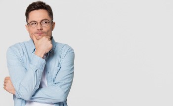 A skeptical-seeming man pondering a question