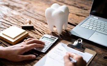 A person filling out a dental insurance form