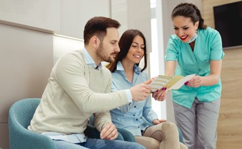 Dental patients paying the cost of Invisalign in Goodyear