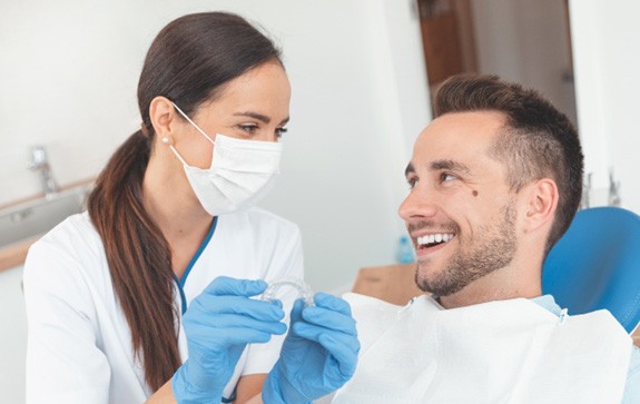A dentist answering questions about Invisalign in Goodyear