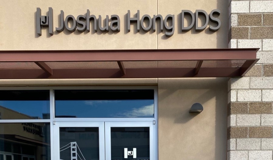 Closeup of Joshua Hong D D S logo on the side of the dental office building