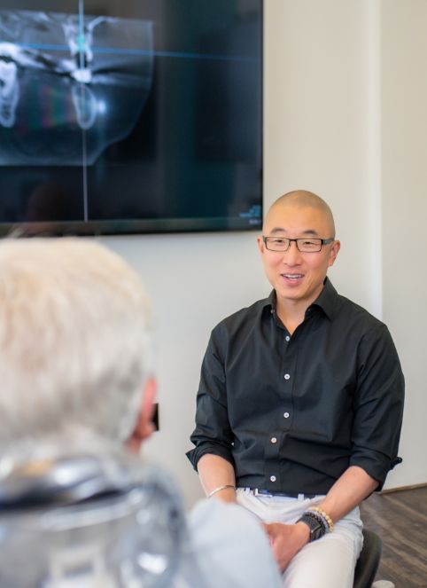 Doctor Hong talking to dental patient during preventive dentistry visit