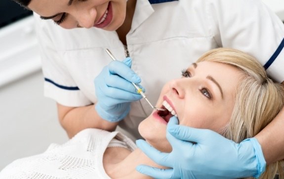 Woman receiving oral cancer screening