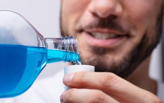 Man using mouthwash