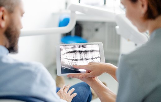 Dentist showing patient the results his X-ray