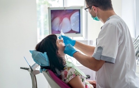 Dentist using intraoral camera to capture smile images