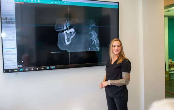 Dental team member showing patient digital x-rays