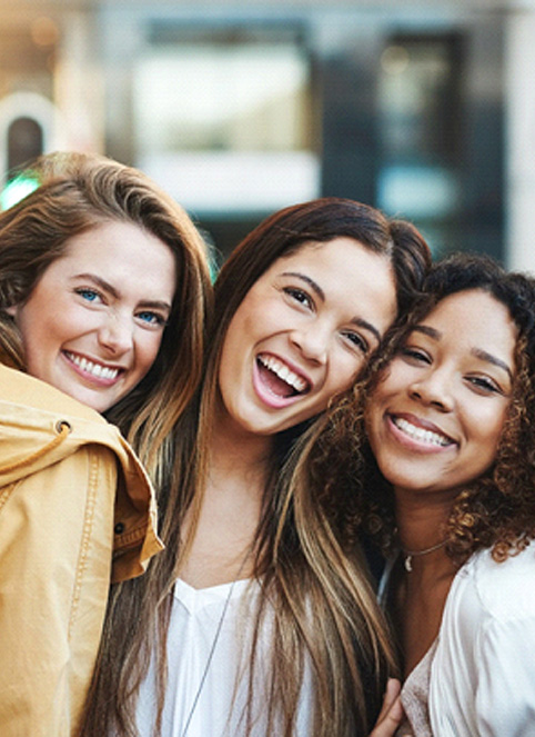 female friends smiling with veneers in Goodyear
