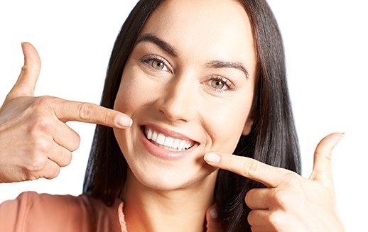 Woman pointing to her teeth