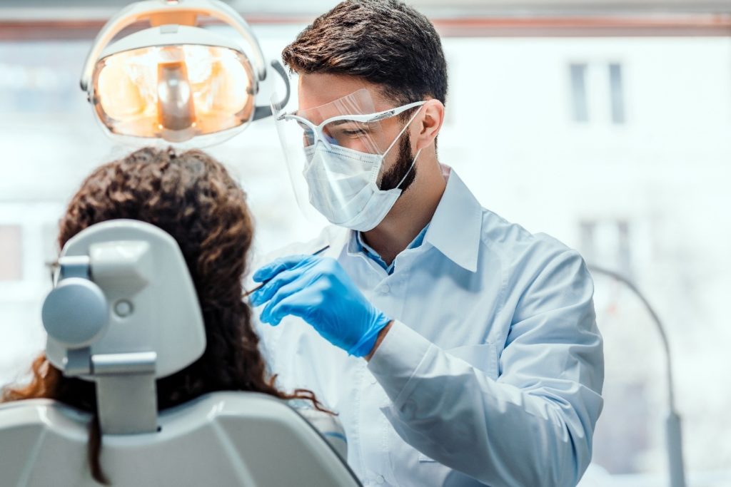 person at dentist having dental crown placed 