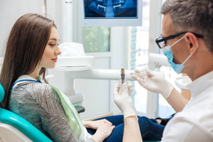 Dentist showing off a dental implant